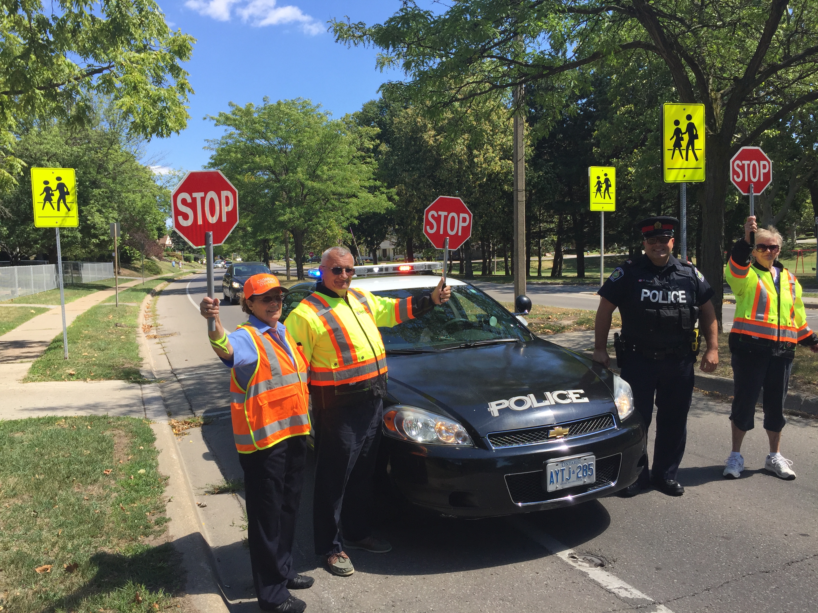 Officer and crossing guards working together