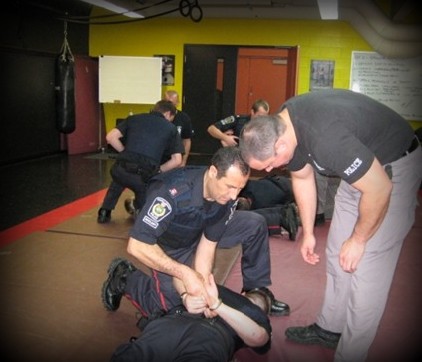 Training Officer Adam Gorski teaching handcuffing techniques
