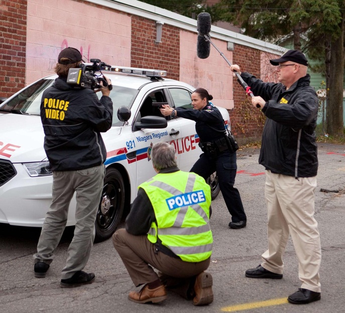 Members of Video Unit taping scene with an officer