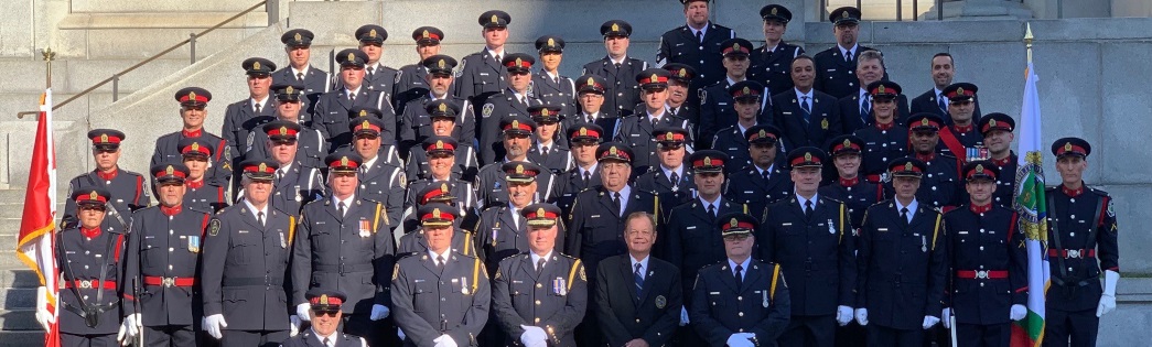 large group of officers in uniform standing on steps