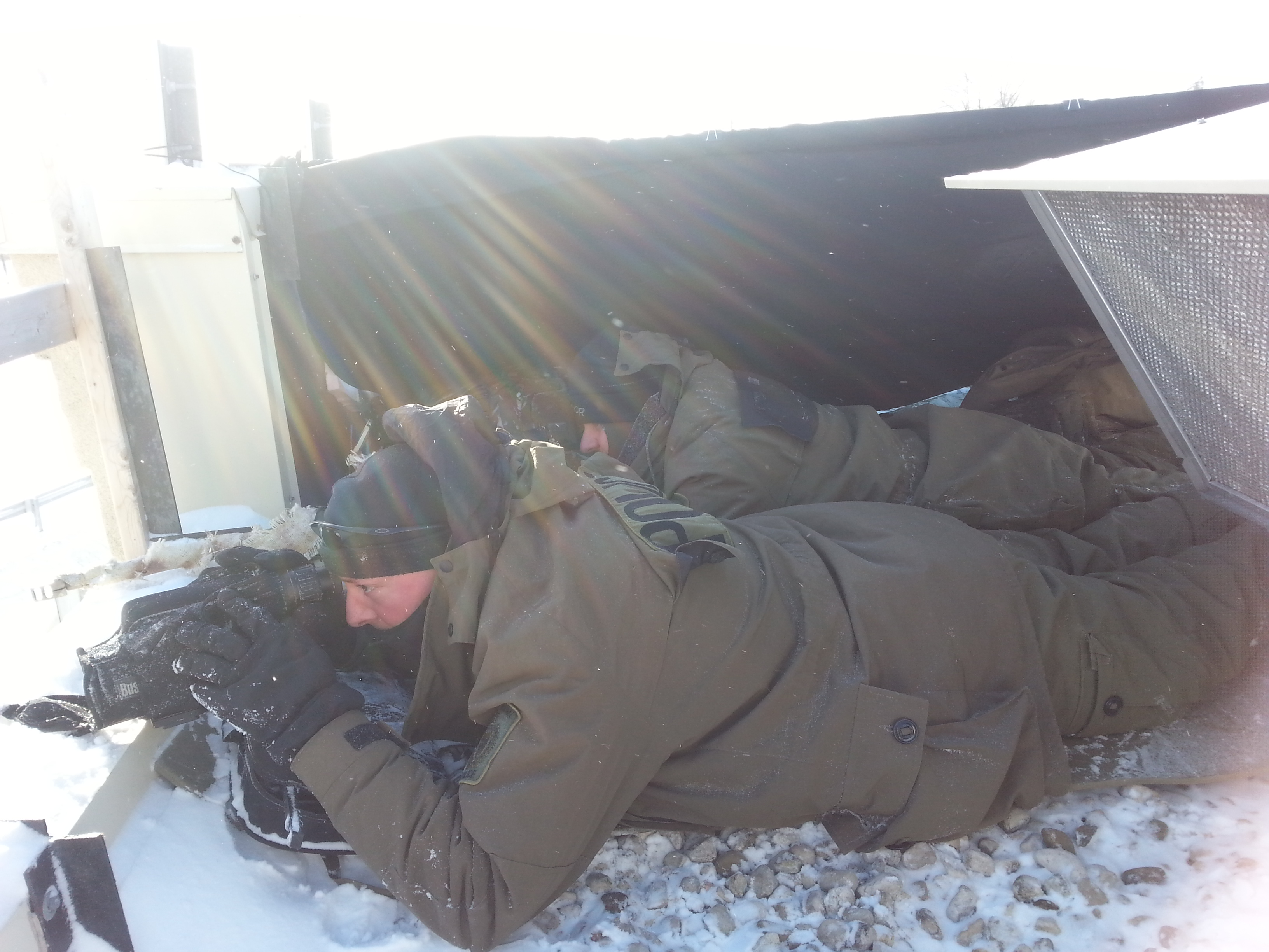 officer laying on the ground watching