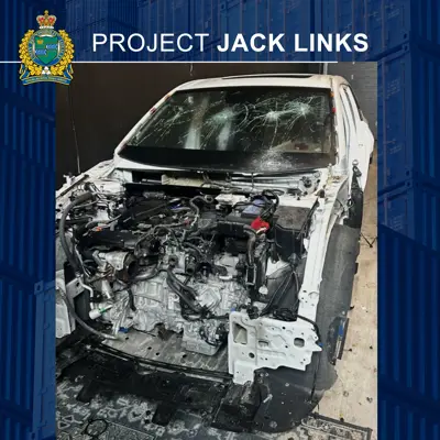 A white vehicle that has been stripped of parts