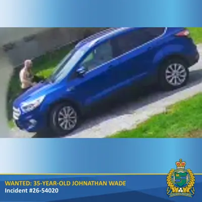 Suspect getting into blue SUV