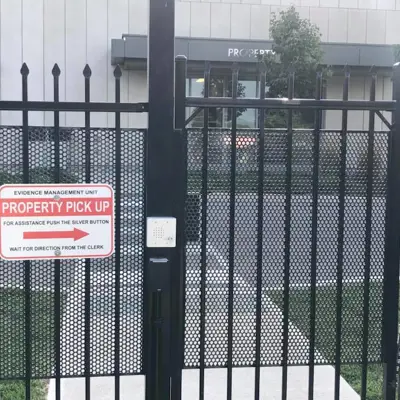 A sign beside a gate entrance