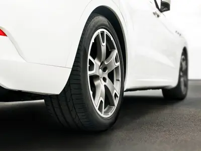 Back wheel of a white sedan