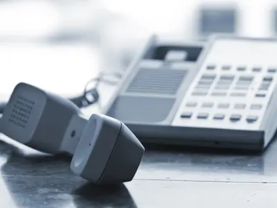 Telephone handset off the hook on desk