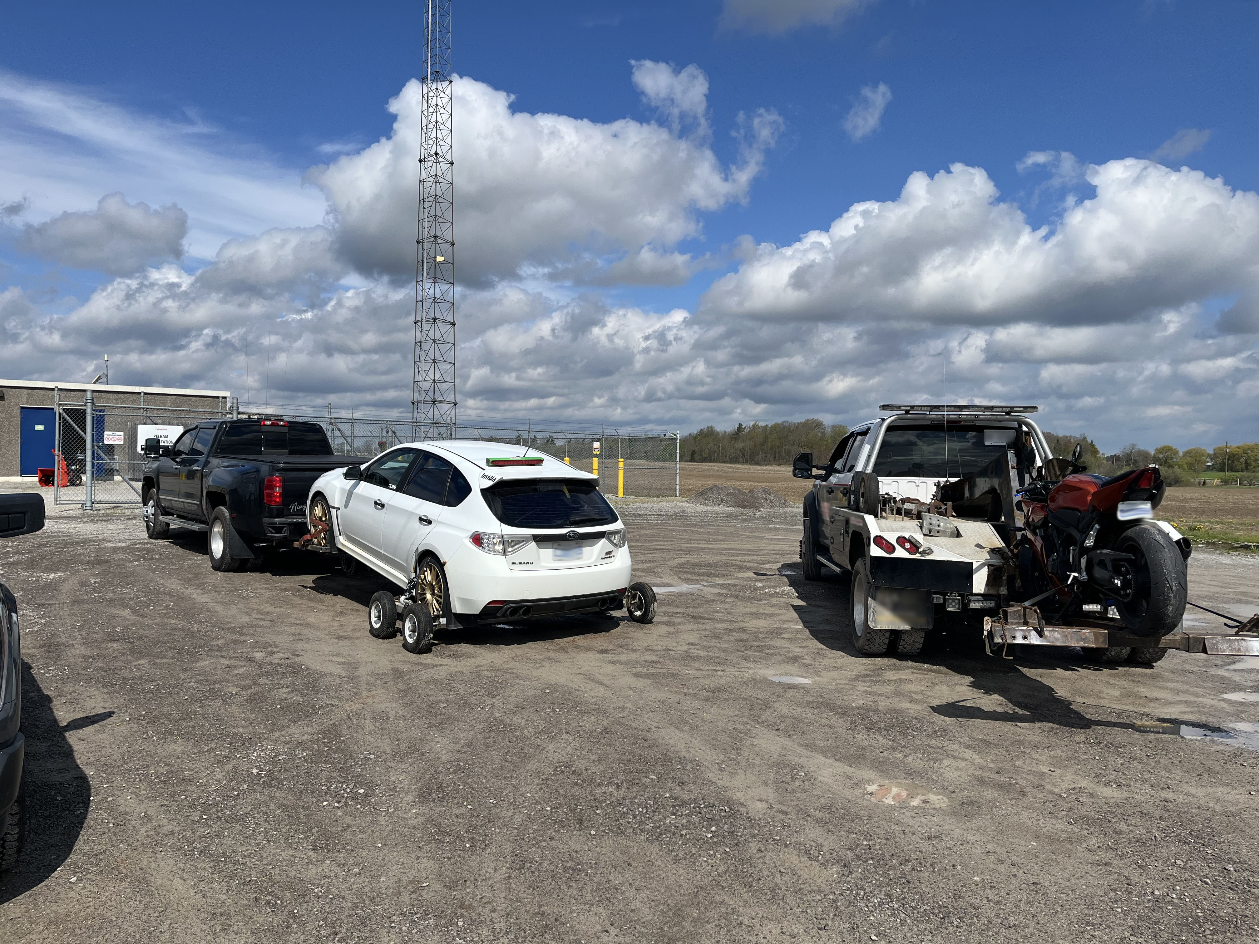 A car and a bike on tow trucks