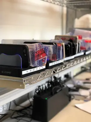 A row of phones in evidence bags on a shelf