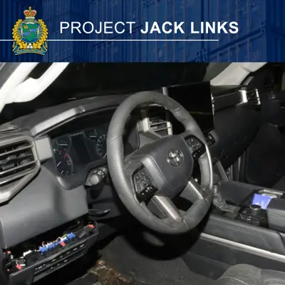 An interior steering wheel of a car with some torn out wiring