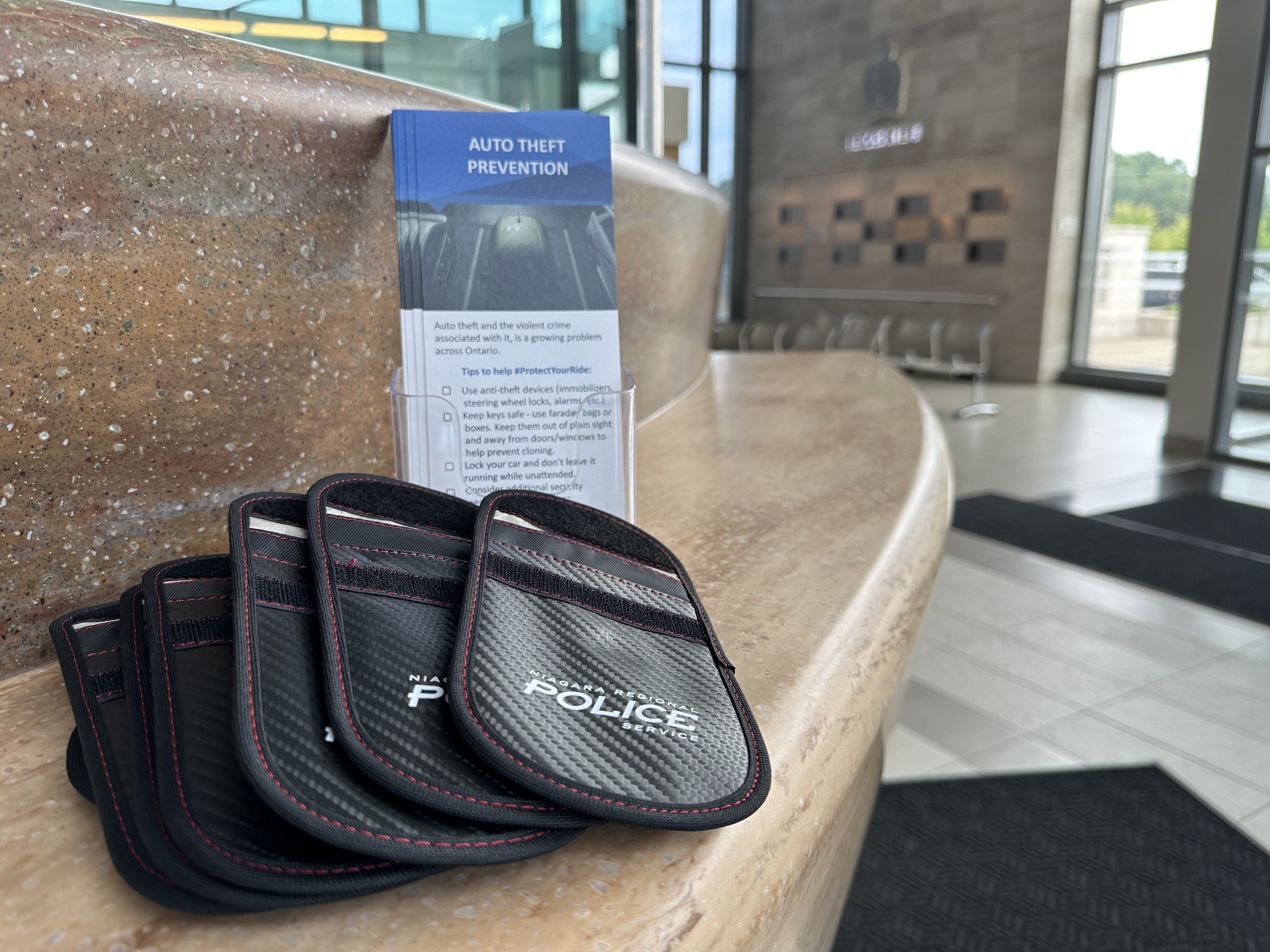 faraday bags on a counter with pamphlets behind them