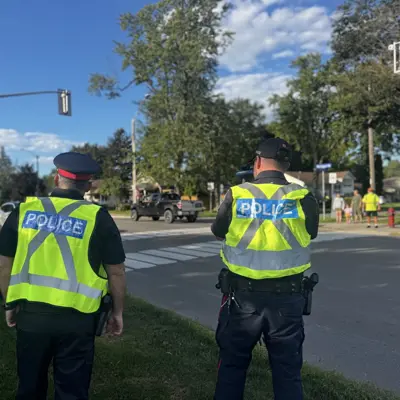 two officers in high visibility vests conducting radar