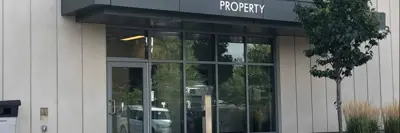 The doors to a building with a sign that says property