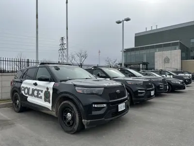 police cars parked outside of a station