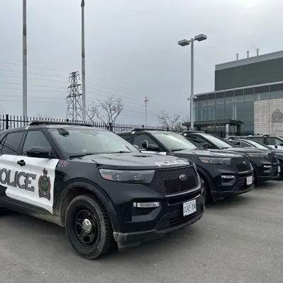 police cars parked outside of a station