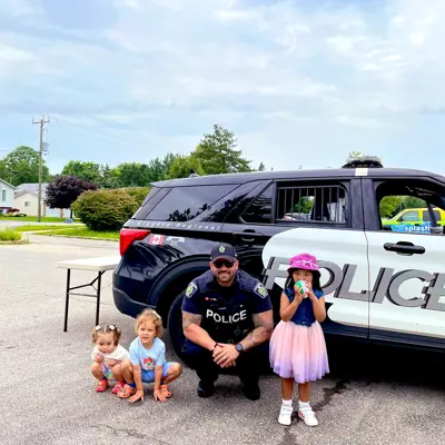 A police officer with kids, outside