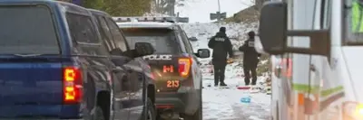 two collision reconstruction officers walking between vehicles
