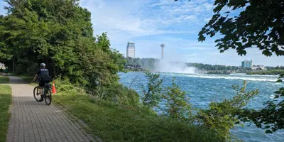 An officer on a trail on a bike
