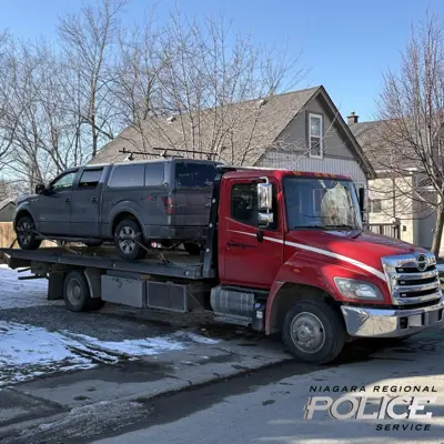 Photo of Seized Truck on Flat Bed Tow Truck